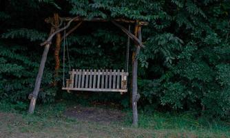 Garden swing in the forest photo