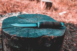 Hunting knife on a wooden surface photo