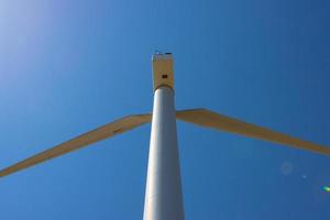 Wind farm, Wind farms. Wind power is the use of air flow through wind turbines to mechanically Power generators for electric power. photo