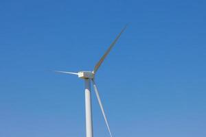 Wind farm, Wind farms. Wind power is the use of air flow through wind turbines to mechanically Power generators for electric power. photo