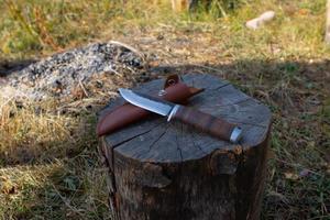 Hunting knife on a wooden surface photo