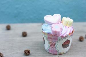 Cupcakes with topping on wooden table for party. photo