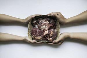 The top view of giving of sacrificial meat on Eid al-Adha isolated by white background photo