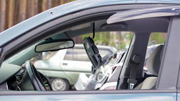 Close-up of the steering wheel of a car after an accident. The driver's airbags did not deploy. Soft focus. Broken windshield with steering wheel. Vehicle interior. Black dashboard and steering wheel. video