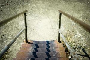 Rusty metal stairs unde the bright sunlight photo