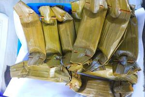 Pepes Tahu. Steamed cake of minced beancurd and spices in banana leaf parcel. photo