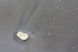 Sand background with stones for summer. Sandy beach texture. Macro shot. Copy space photo