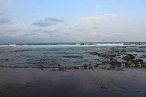 Sea Ocean Wave hit the rock at beach. Seascape. Focus on foreground photo