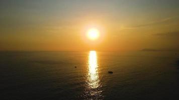 Calm sea with sunset sky and sun over clouds. Meditation ocean and sky background. video
