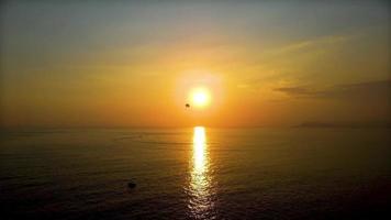 Calm sea with sunset sky and sun over clouds. Meditation ocean and sky background. video