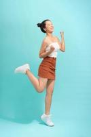 Asian young woman jumping and expressing happiness. photo