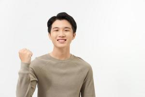 Happy excited Asian man raising his arm up to celebrate success photo