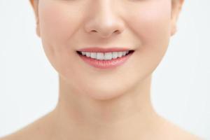 Beautiful young woman with healthy teeth on white background photo