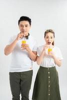 love, family, healthy food and happiness concept - smiling happy couple drinking juice on white background photo