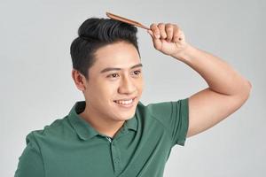 handsome young man brushing his hair photo