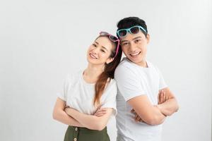 Cheerful hsppy man and woman with crossed hands standing back to back. photo