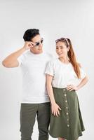 Studio shot of two surprised terrific woman and man look in bewilderment, touch rim of spectacles, being amazed by sudden news, stand against white background photo