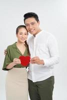 young love couple holding red heart, happy smile embrace, isolated over white background, valentine day concept photo