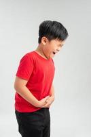unhappy Little boy showing stomach pain photo