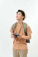 Traveler and photographer. Studio portrait of handsome young man holding photocamera taking photo. photo