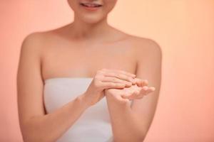 Woman applying moisturizing hands with cream, photo