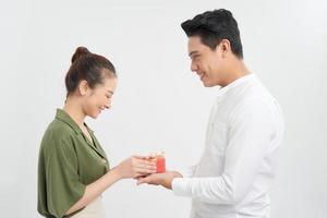 Handsome man makes present to his girlfriend, isolated on white photo