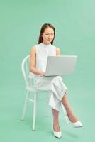 Beautiful and happy woman working with a laptop photo