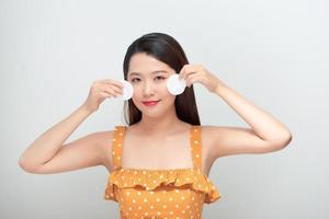 Young cute woman remove makeup , cleaning face with cotton pads photo