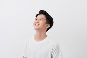 Handsome young man over grey grunge wall with a happy face standing and smiling with a confident smile showing teeth photo