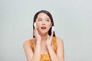 Woman removing makeup with cleansing pad photo