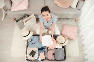 Cheerful Female Packing Suitcase And Getting Ready For Traveling