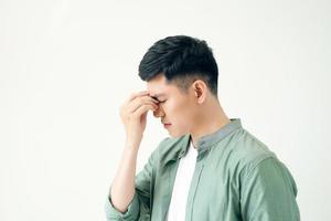 Depressed young business man holding his head photo