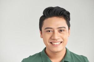 Happy young man smiling with joy and looking at camera isolated on white background photo