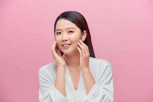 Female Skin Care. Young asian woman touching her face photo