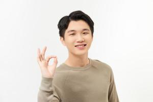 young man shows sign and symbol ok on white background photo