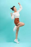 Studio portrait of surprised positive girl dancing with smile. photo