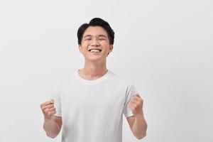 Close-up daylight portrait of young smiling handsome man isolated on gray background photo