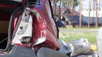 Red car after a terrible accident on the side of the road. Frontal and side impact. Life insurance. An accident without the possibility of recovery. Back view. Damage after an accident. video