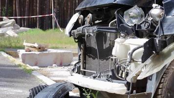 Schwarzes Auto nach einem schrecklichen Unfall am Straßenrand. Frontal- und Seitenaufprall. Lebensversicherung. ein Unfall ohne Heilungsmöglichkeit. Seitenansicht. Schäden nach einem Unfall. video