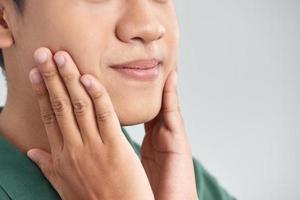 Men Face Care. Man Touching Smooth Skin After Shaving photo