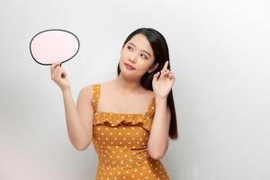 Attractive asian female with empty message box isolated on white background. photo