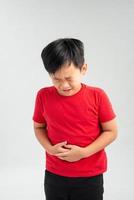 Asian boy with problems stomach ache isolated on white background photo