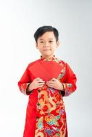 Cute asian boy in traditional Vietnamese ao dai Isolated on white background, Lunar New Year Concept photo