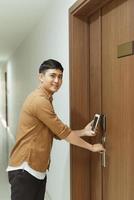 Male hand using smartphone for sensor scanning. Infrared sensor technology for automatic door access and security. photo