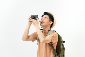 Smiling traveler tourist man in yellow summer clothes with photo camera isolated
