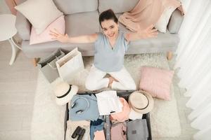 Portrait of a girl packing things and looking at camera photo