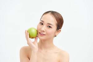 Pretty healthy young woman smiling holding a green apple photo