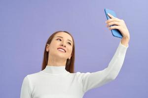 Selfie time. Joyful young women making selfie by her smart phone photo