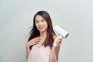 Portrait of happy young woman blow-dry photo