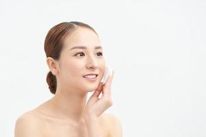 Portrait of beautiful lovely pretty well-groomed charming lady with her naked shoulders she isolated  use micellar water and circle white pad photo